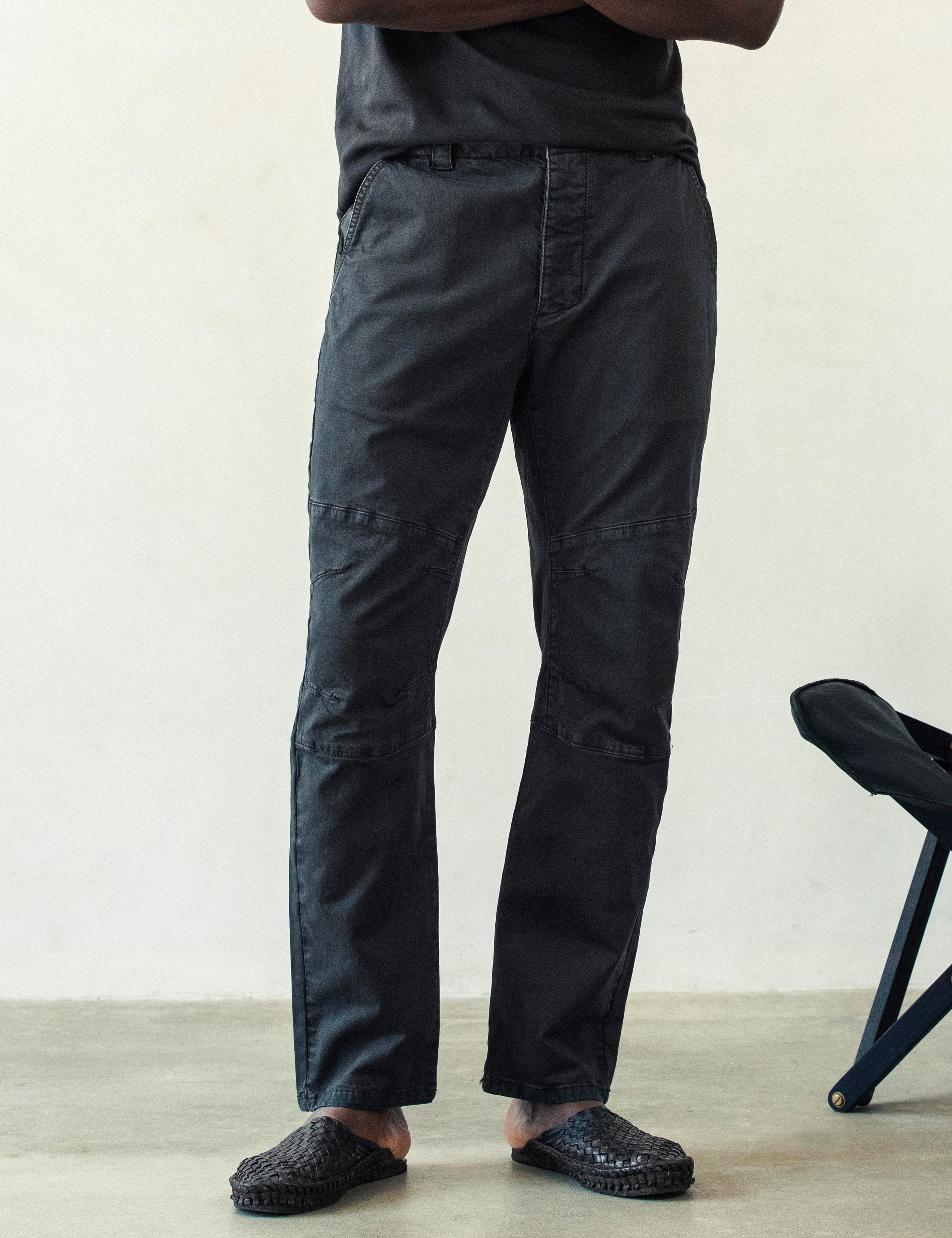 Front lower body view of man wearing Gabriel Articulated Chino Stretch pant in Tarmac Black from AETHER Apparel.