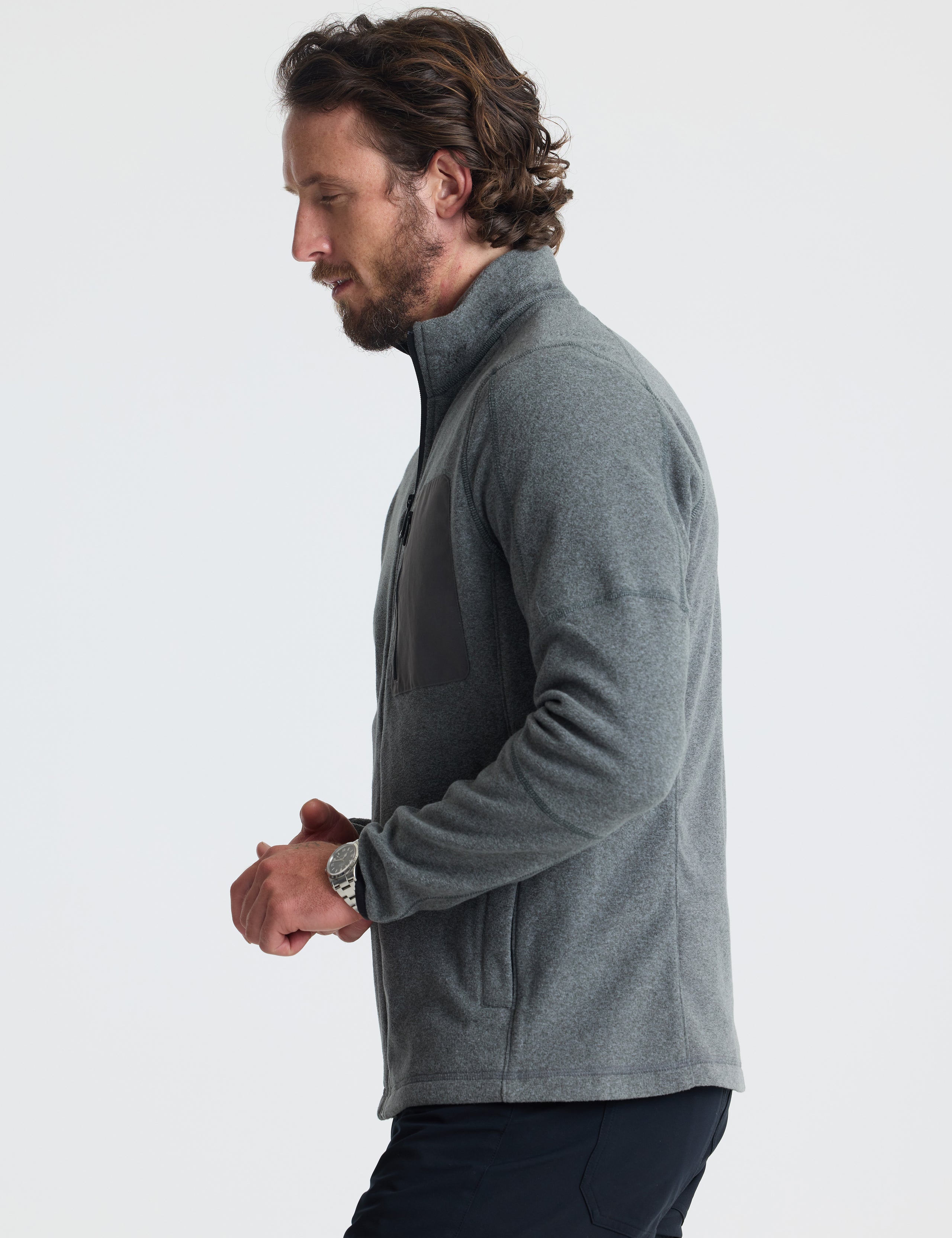 Left profile of man wearing Sutherlin Full-Zip in Charcoal Grey from AETHER Apparel.